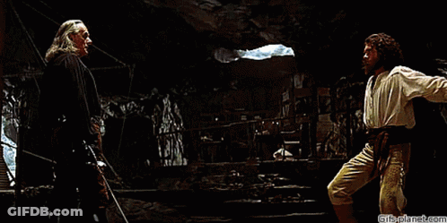 Two Men Are Fighting In A Dark Room With Gifsplanet.com At The Bottom Of The Image GIF