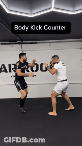 Two Men Are Fighting In A Gym With The Words Body Kick Counter On The Bottom GIF
