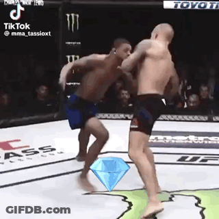 Two Men Are Fighting In A Ring With A Diamond In The Middle . GIF