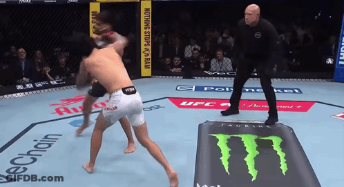 Two Men Are Fighting In A Ring With A Monster Energy Drink On The Ground GIF