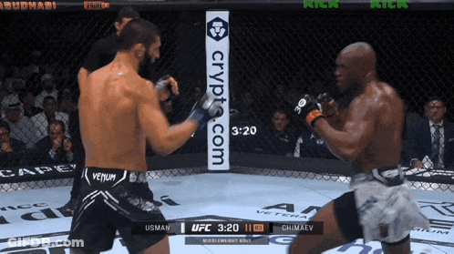 Two Men Are Fighting In A Ring With A Sign That Says Crypt.com On It GIF
