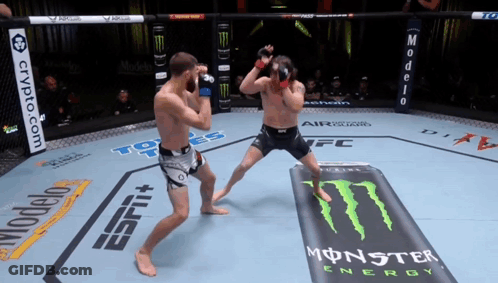 Two Men Are Fighting In A Ring With Monster Energy Advertisements GIF