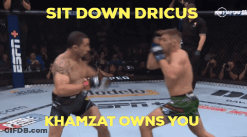 Two Men Are Fighting In A Ring With The Words Sit Down Drius Khamzat Owns You Above Them GIF