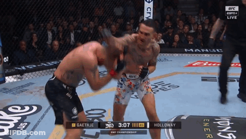 Two Men Are Fighting In A Ufc Ring And The Clock Shows 3:07 GIF