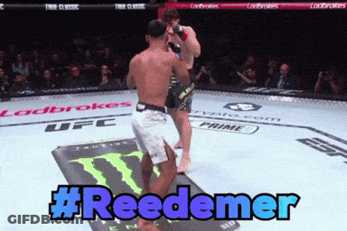 Two Men Are Fighting In A UFC Ring And The Hashtag #Reedemer Is Displayed GIF