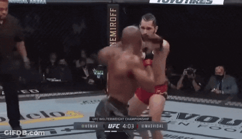 Two Men Are Fighting In A Ufc Welterweight Championship Match Between Husman And Masvidal GIF