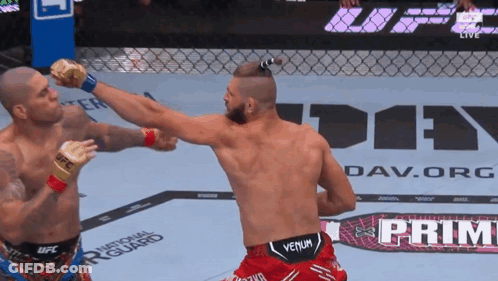 Two Men Are Fighting In Front Of A Sign That Says " Prime " GIF