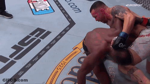 Two Men Are Fighting On A Boxing Ring With A Sign That Says Prime GIF