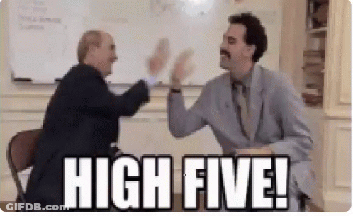 Two Men Are Giving Each Other A High Five In A Room . GIF