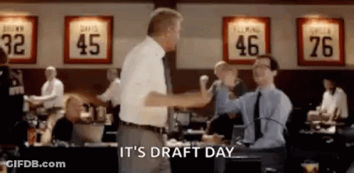Two Men Are Giving Each Other A High Five In A Room . GIF