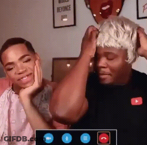 Two Men Are Having A Video Call And One Of Them Is Wearing A Wig GIF