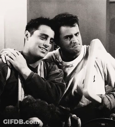 Two Men Are Hugging Each Other And One Has The Number 1 On His Shirt GIF