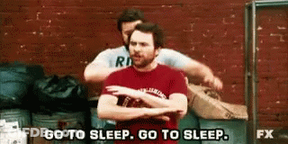 Two Men Are Hugging Each Other In Front Of A Brick Wall And One Of Them Is Saying `` Go To Sleep , Go To Sleep '' GIF