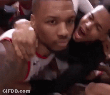 Two Men Are Hugging Each Other On A Basketball Court And One Is Screaming . GIF