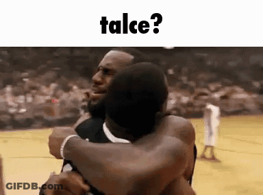 Two Men Are Hugging Each Other On A Basketball Court With The Words Talce Written Above Them . GIF