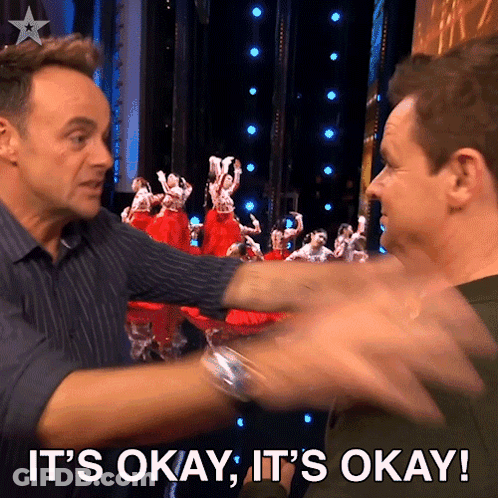 Two Men Are Hugging Each Other With The Words It 'S Okay It 'S Okay Behind Them GIF