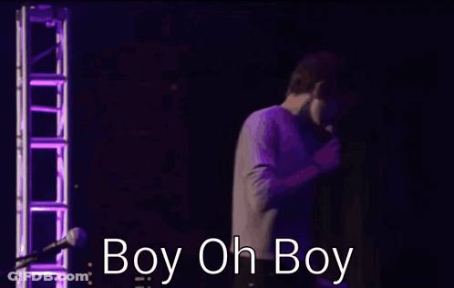 Two Men Are Hugging In Front Of A Microphone And The Words Boy Oh Boy Are Visible GIF