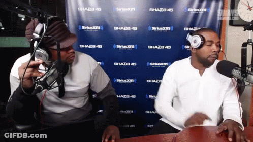 Two Men Are In Front Of A Siriusxm Wall GIF