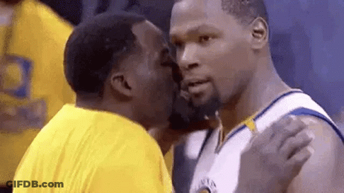 Two Men Are Kissing Each Other On The Cheek . GIF