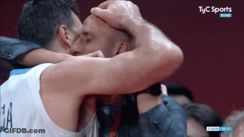 Two Men Are Kissing In Front Of A Tv Screen That Says Tyc Sports Vivo GIF