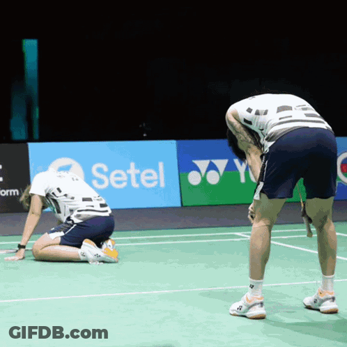 Two Men Are Kneeling On A Tennis Court In Front Of A Setel Ad GIF