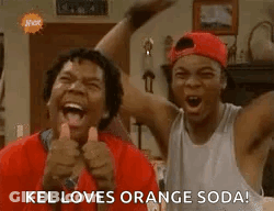 Two Men Are Laughing And Giving A Thumbs Up While Standing Next To Each Other In A Living Room . GIF