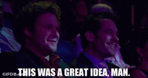 Two Men Are Laughing In A Crowd And One Of Them Is Saying This Was A Great Idea Man . GIF