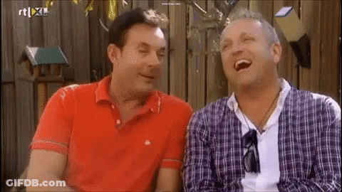 Two Men Are Laughing In Front Of A Sign That Says Rt Xl On It GIF