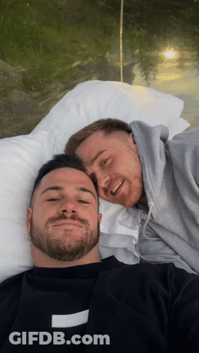 Two Men Are Laying Next To Each Other On A Bed And One Of Them Has A Black Shirt That Says ' Off White ' On It GIF