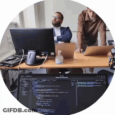 Two Men Are Looking At A Computer Monitor That Says Asus On It GIF