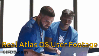 Two Men Looking At Laptop With Real Atlas OS Footage GIF