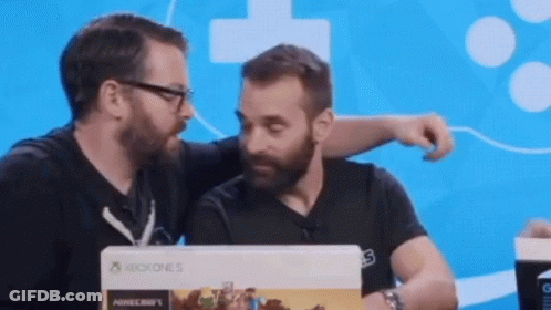 Two Men Are Looking At A Xbox One S Box GIF