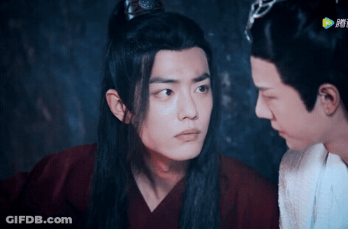 Two Men Are Looking At Each Other And One Is Wearing A Crown On His Head GIF