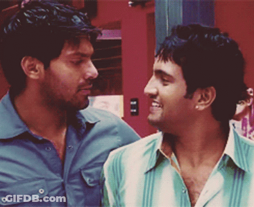 Two Men Are Looking At Each Other And One Of Them Is Wearing A Green Shirt GIF
