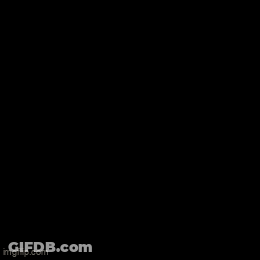 Two Men Are Looking Through A Glass Door At A Statue Of A Woman GIF