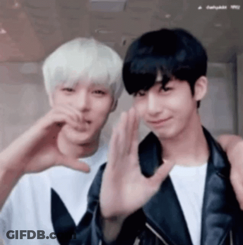 Two Men Are Making A Heart Shape With Their Hands . GIF