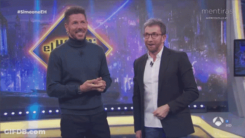 Two Men Are On A Stage With A Sign That Says Mentiras GIF