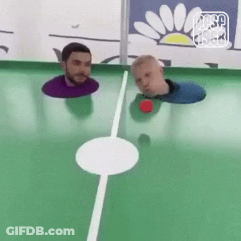 Two Men Are Playing A Game Of Pool With Their Heads In The Hole . GIF