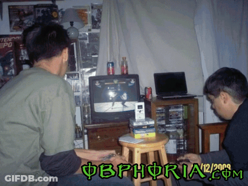 Two Men Are Playing A Video Game With The Date 12/2009 On The Bottom GIF