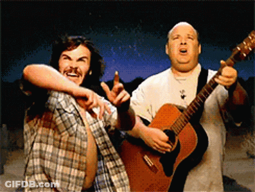 Two Men Are Playing Guitars And One Is Pointing GIF