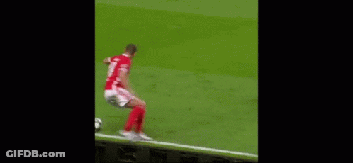 Two Men Are Playing Soccer On A Field And One Of Them Is Wearing A Number 21 Jersey . GIF