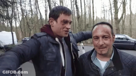 Two Men Are Posing For A Picture And One Has A Bruise On His Head GIF