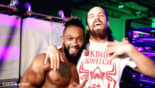 Two Men Are Posing For A Picture With One Wearing A King Switch Shirt GIF