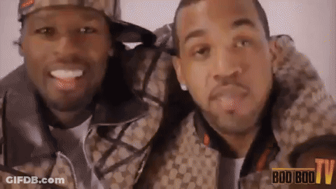 Two Men Are Posing For A Picture With The Words Boo Boo TV In The Background GIF