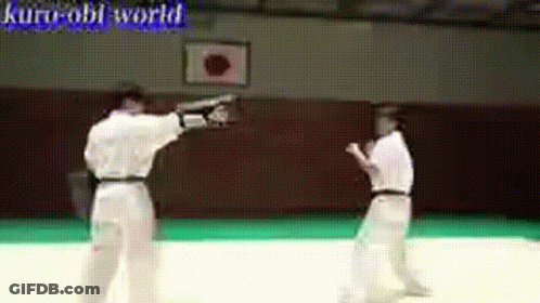 Two Men Are Practicing Martial Arts In A Gym With The Words Kuro-Obi World Written On The Bottom GIF
