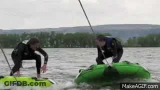 Two Men Are Riding Tubes On A Lake With Makeagif.com At The Bottom Of The Screen GIF