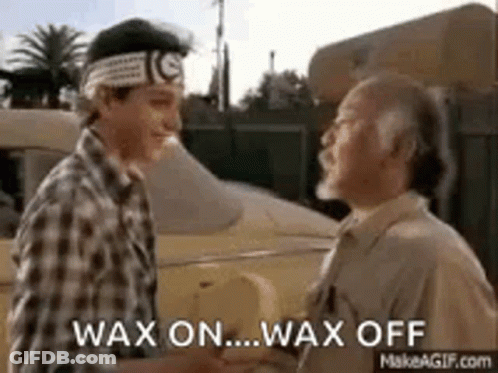 Two Men Are Shaking Hands In Front Of A Car And Talking . GIF