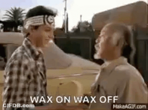 Two Men Are Shaking Hands In Front Of A Car And They Are Talking To Each Other . GIF