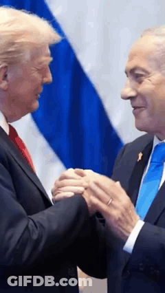 Two Men Are Shaking Hands In Front Of A Flag GIF
