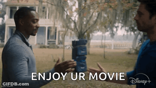 Two Men Are Shaking Hands In Front Of A House And The Words `` Enjoy Ur Movie '' Are Written On The Bottom . GIF